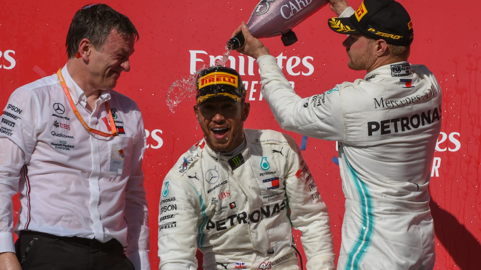 Teammate Mercedes AMG Petronas Motorsport driver Valtteri Bottas (77) of Finland pours champagne on the head of Mercedes AMG Petronas Motorsport driver Lewis Hamilton (44) of Great Britain after clinching the 2019 FIA Formula 1 World Championship following the F1 - U.S. Grand Prix race at Circuit of The Americas on November 3, 2019 in Austin, Texas.