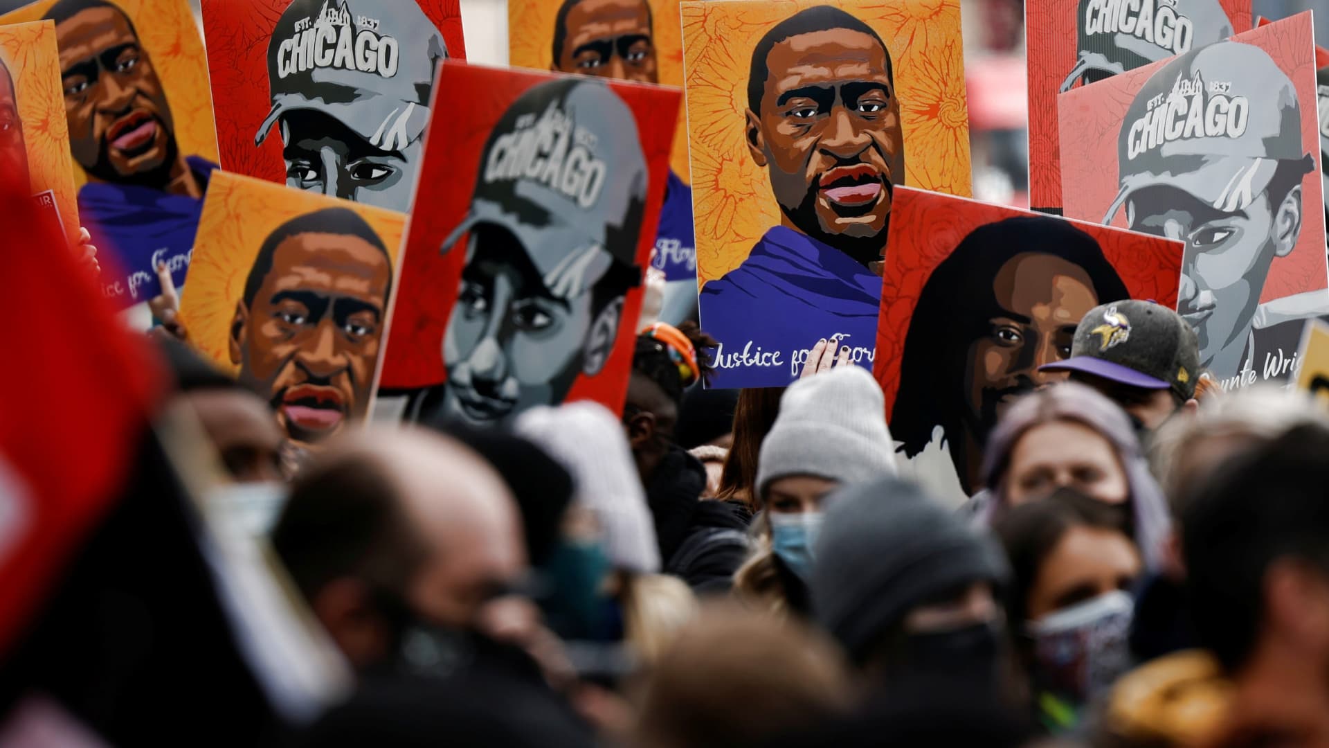 People hold placards after the verdict in the trial of former Minneapolis police officer Derek Chauvin, found guilty of the death of George Floyd, in front of Hennepin County Government Center, in Minneapolis, Minnesota, April 20, 2021.
