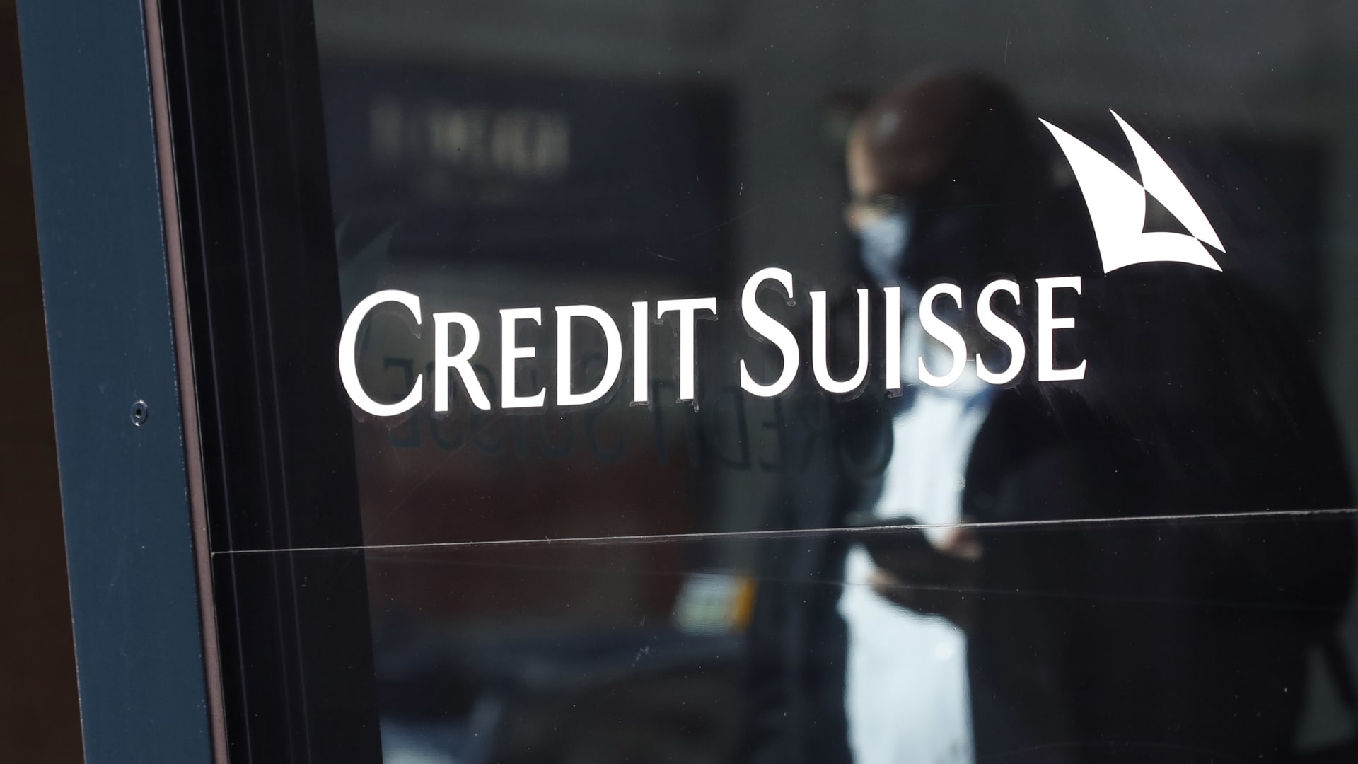 A Credit Suisse logo in the window of a Credit Suisse Group AG bank branch in Zurich, Switzerland.
