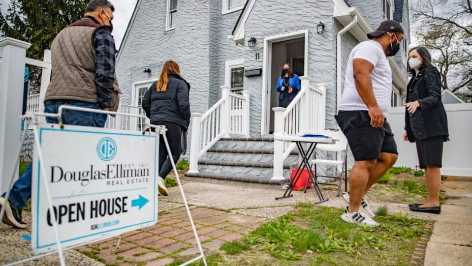 Real estate agents Rosa Arrigo, center, and Elisa Rosen, right, work an open house in West Hempstead, New York on April 18, 2021.