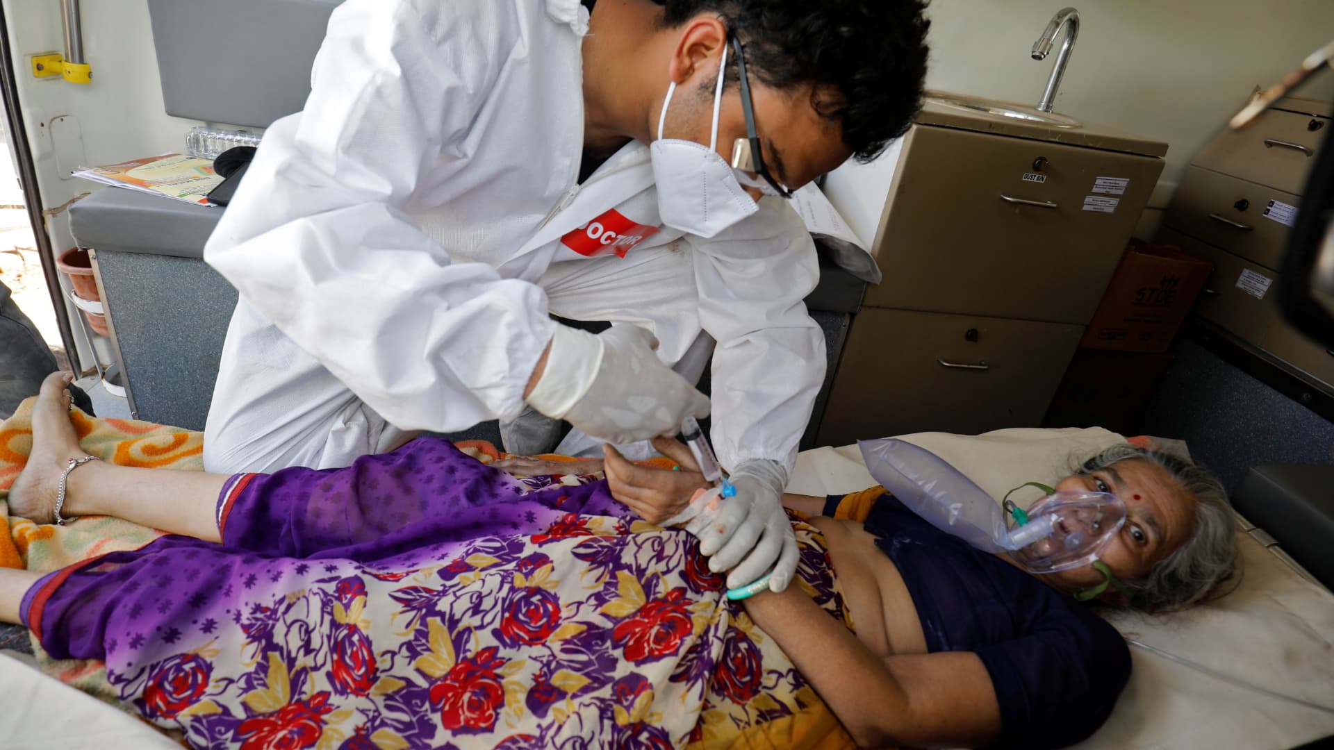 A doctor tends to a patient with a breathing problem inside an ambulance waiting to enter a COVID-19 hospital for treatment, amidst the spread of the coronavirus disease (COVID-19) in Ahmedabad, India, April 25, 2021.