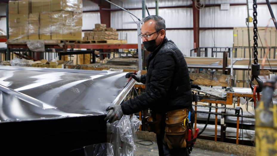 Carlos Hernandez installs an aluminium roof at Look Trailers cargo trailer manufacturing facility in Middlebury, Indiana, April 1, 2021.