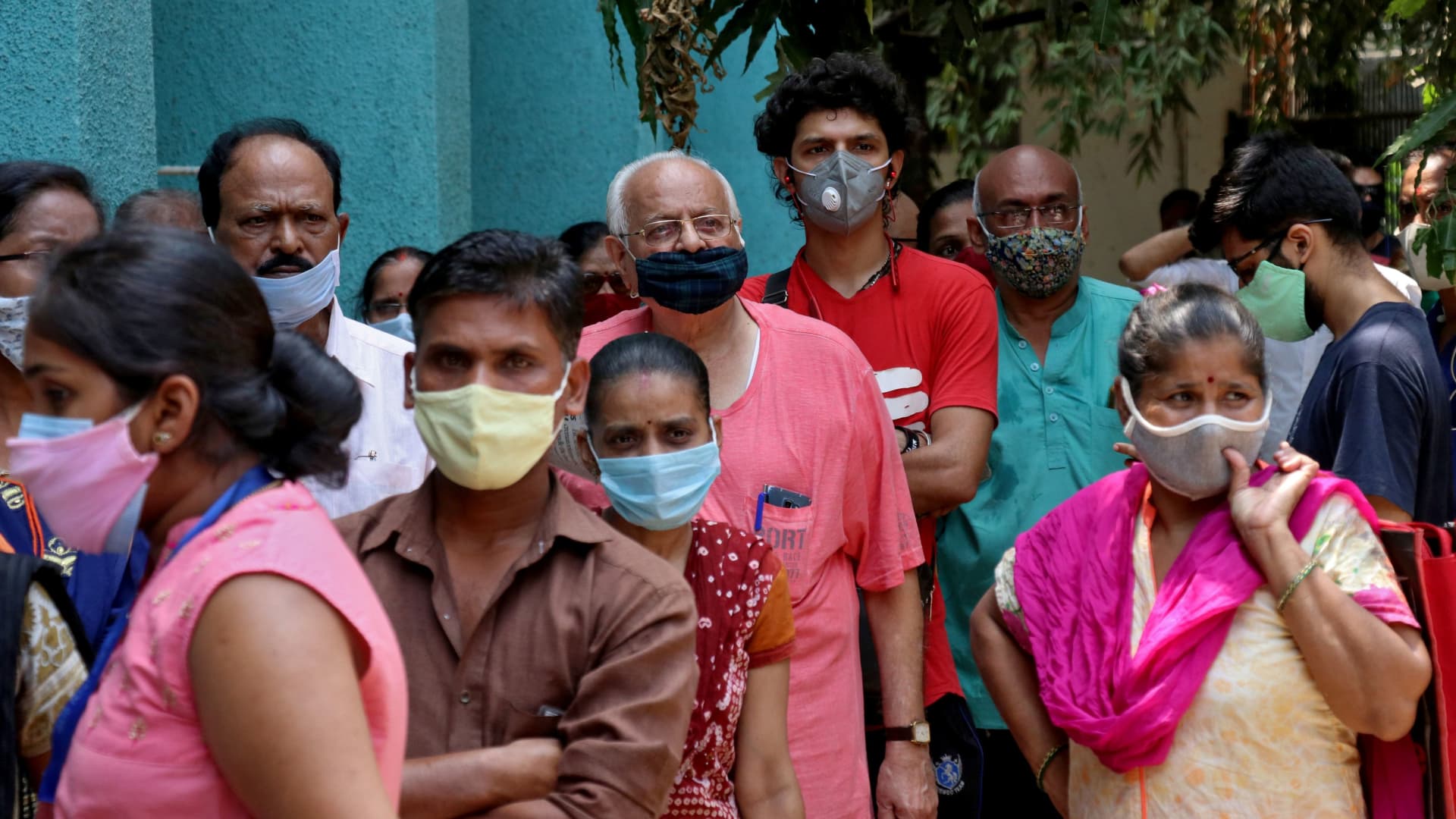 People wearing protective face masks wait to receive a vaccine against the coronavirus disease (COVID-19) at a vaccination centre in Mumbai, India, April 28, 2021.