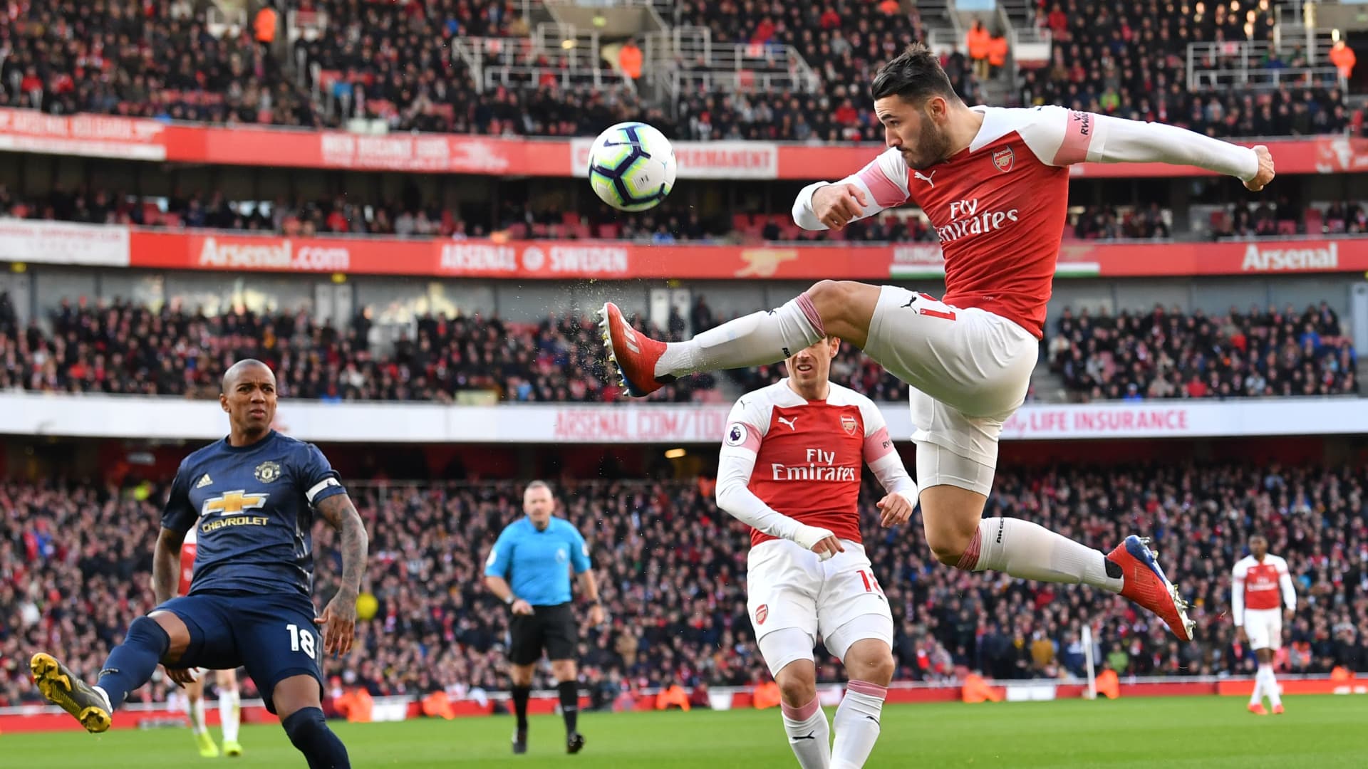 Arsenal's German-born Bosnian defender Sead Kolasinac (R) plays the ball during the English Premier League football match between Arsenal and Manchester United at the Emirates Stadium in London on March 10, 2019.