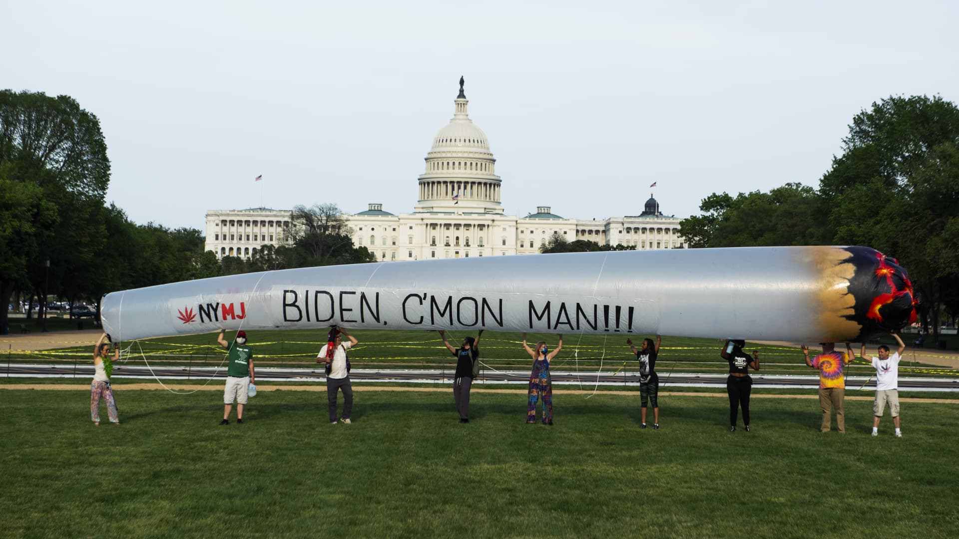 Members of the DC Marijuana Justice community hold a 51 blow-up joint on the National Mall ahead of President Joe Bidens address to a joint session of Congress to call on the administration to take action on legalization and expungement of criminal records on Wednesday, April 28, 2021.