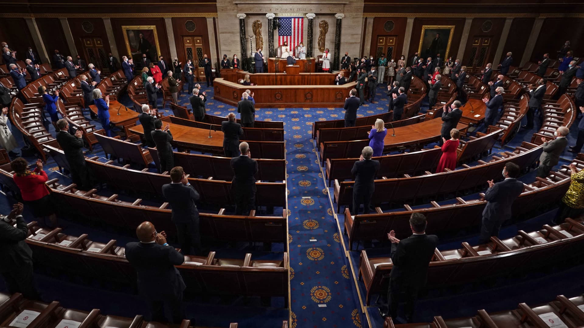 Socially distanced members of Congress stand as US President Joe Biden addresses a joint session of Congress at the US Capitol in Washington, DC, on April 28, 2021.