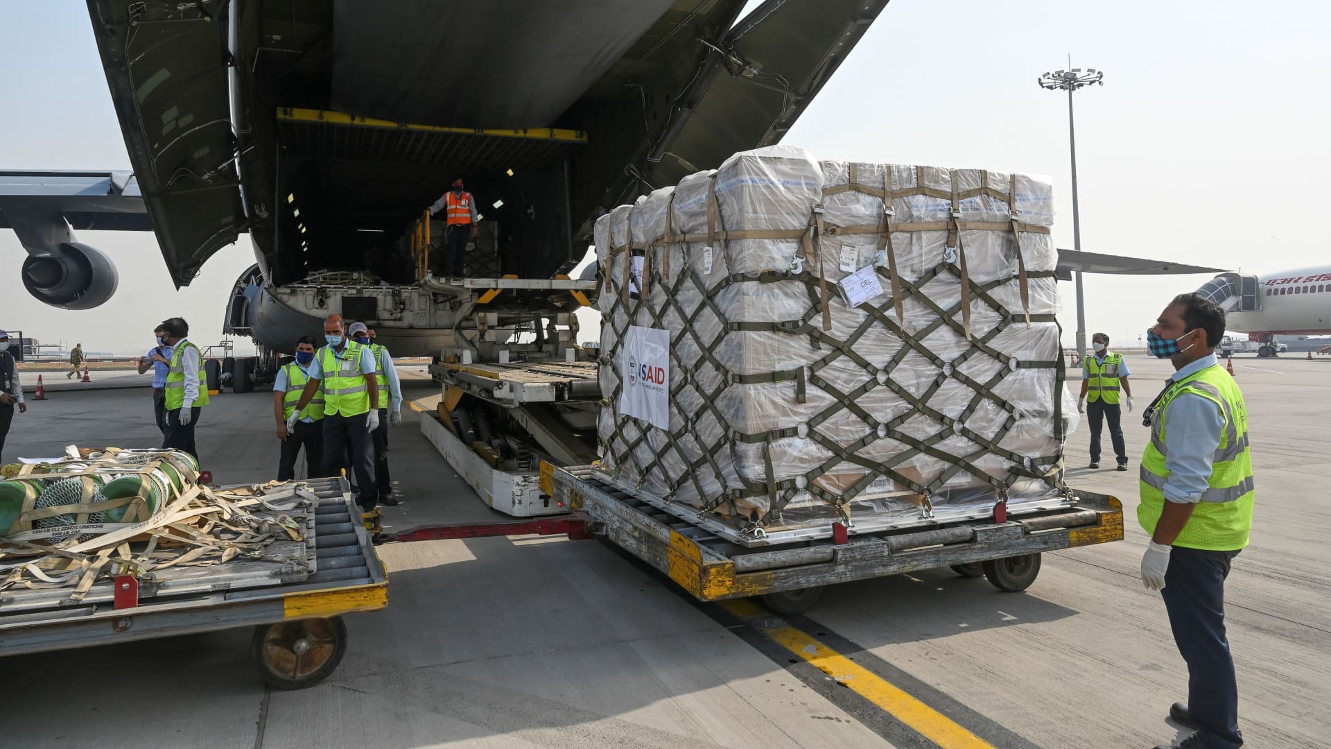 Ground staff unload coronavirus disease (COVID-19) relief supplies from the United States at the Indira Gandhi International Airport cargo terminal in New Delhi, India April 30, 2021.