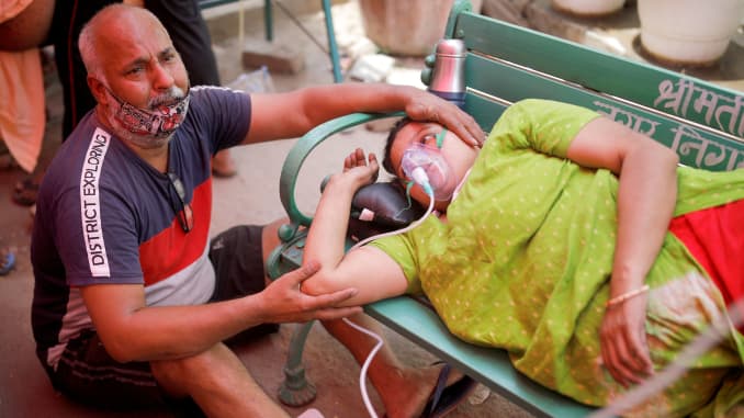Mukesh Bhardwaj cries as he sits next to his wife, who receives oxygen support for free for people suffering from breathing problems, outside a Gurudwara (Sikh temple), amidst the spread of the coronavirus disease (COVID-19), in Ghaziabad, India, May 3, 2