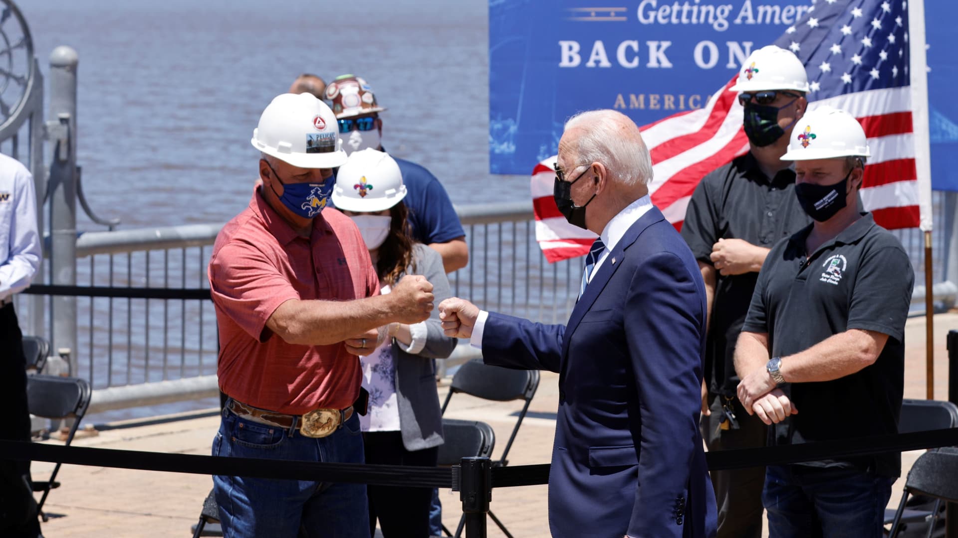 President Joe Biden bumps fist with a man before delivering remarks on his American Jobs Plan near the Calcasieu River Bridge in Lake Charles, Louisiana, U.S., May 6, 2021.