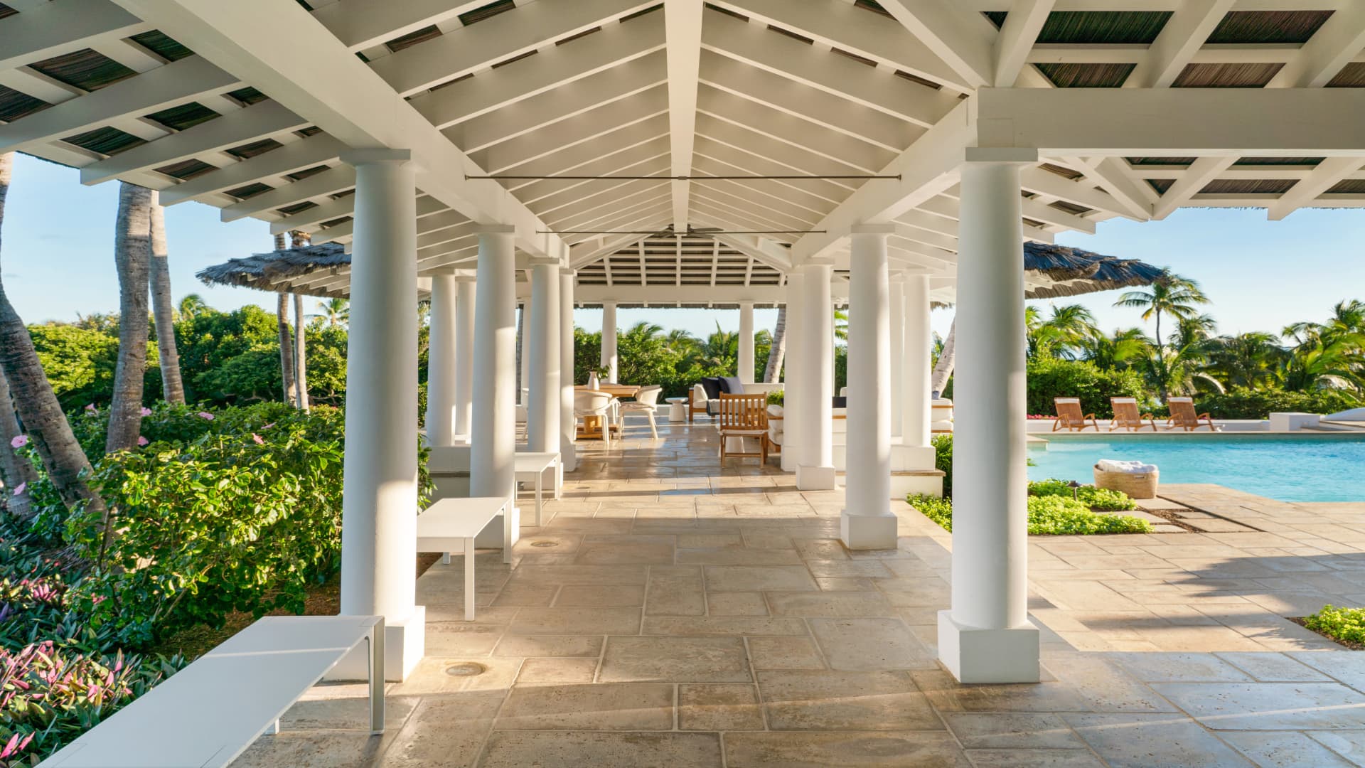 The breezeway leading from the main house to a dining area adjacent to the pool.