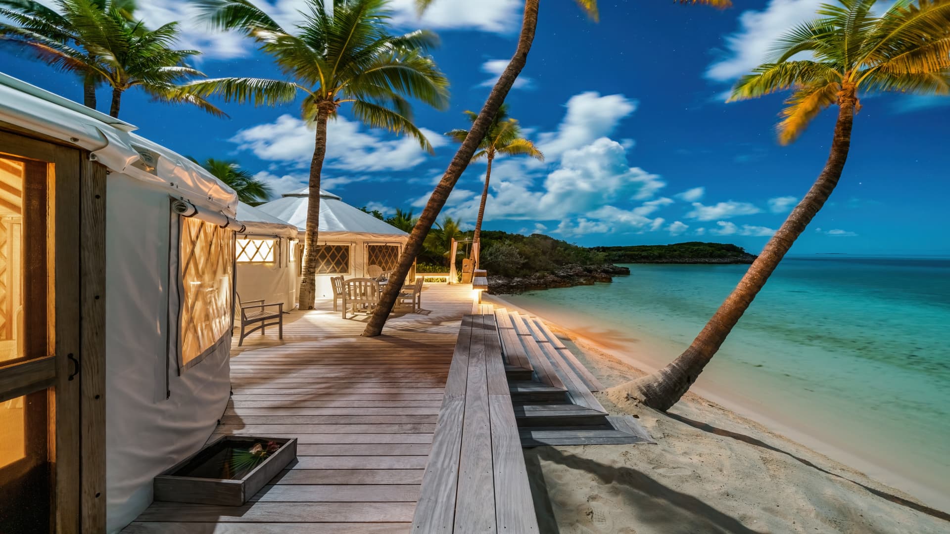 Beachfront yurts with wood decks are steps away from the water's edge.