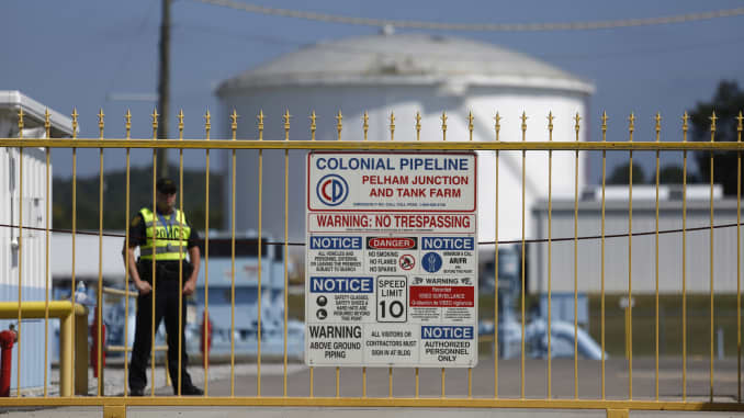 A police officer stands guard inside the gate to the Colonial Pipeline Co. Pelham junction and tank farm in Pelham, Alabama, U.S., on Monday, Sept. 19, 2016.