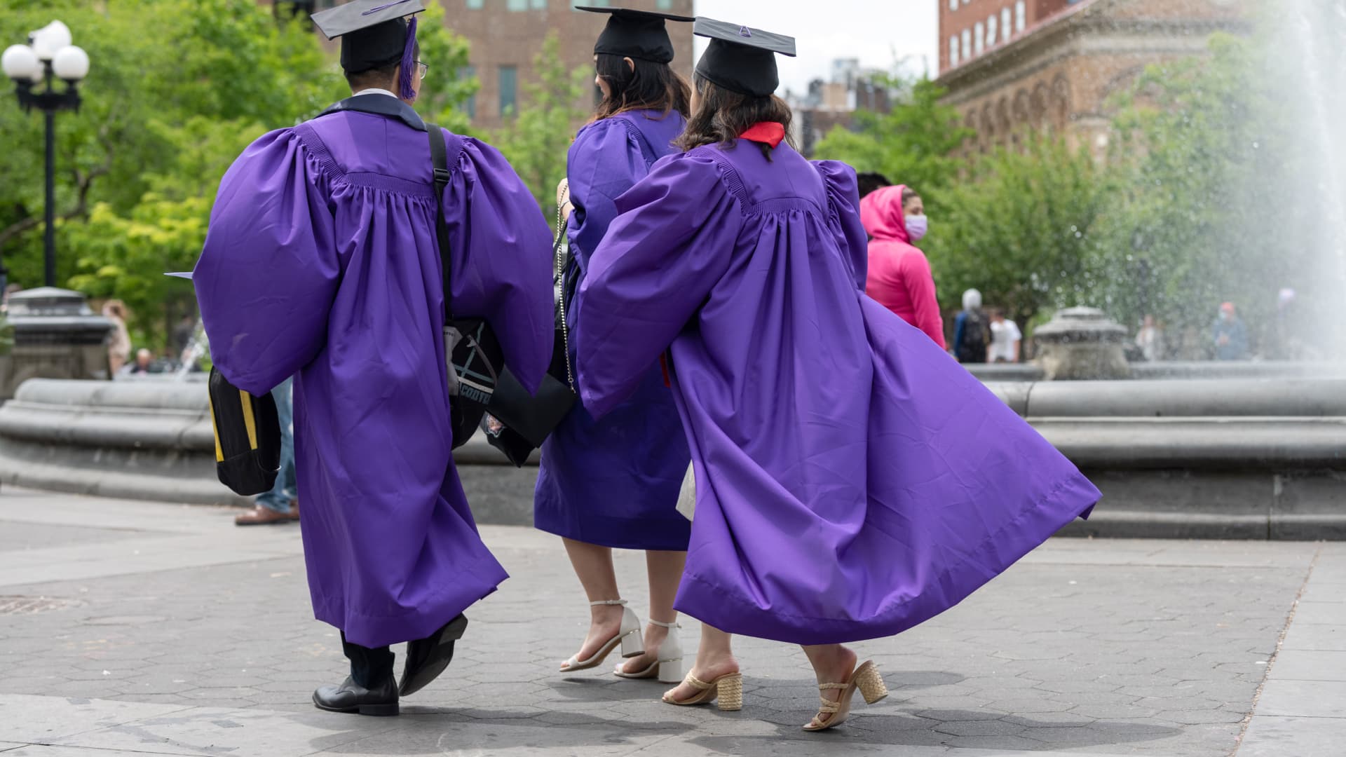 New York University graduates walk through New York's Washington Square Park on May 9, 2021.