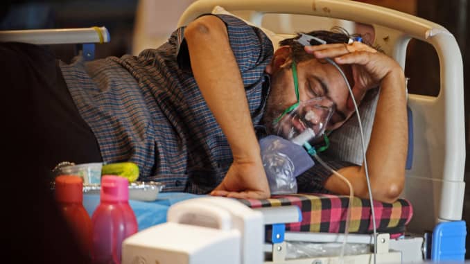 A Covid-19 coronavirus patient rests inside a banquet hall temporarily converted into a Covid care centre in New Delhi on May 10, 2021.
