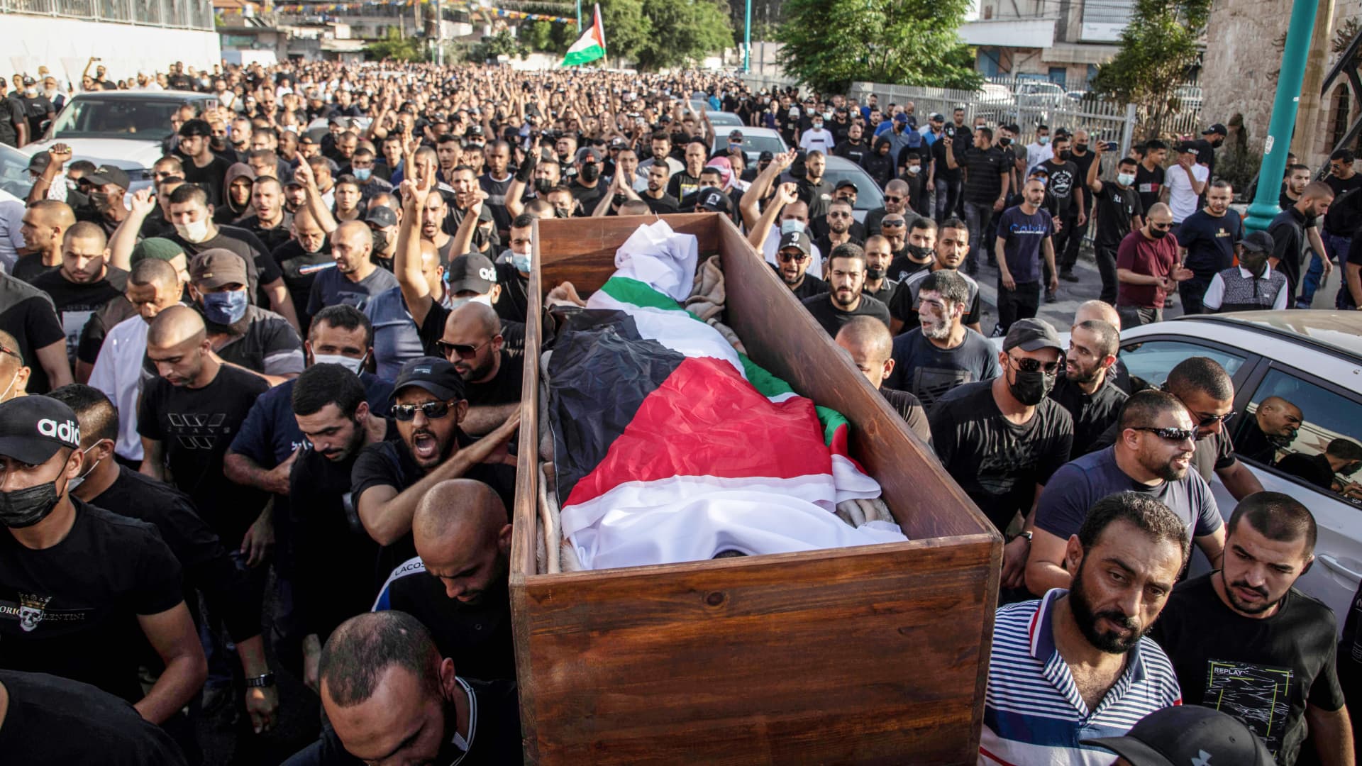 Israeli Arabs carry the coffin of a 25-year-old Israeli-Arab man, who was shot and killed during riots the previous night, during his funeral in the city of Lod.