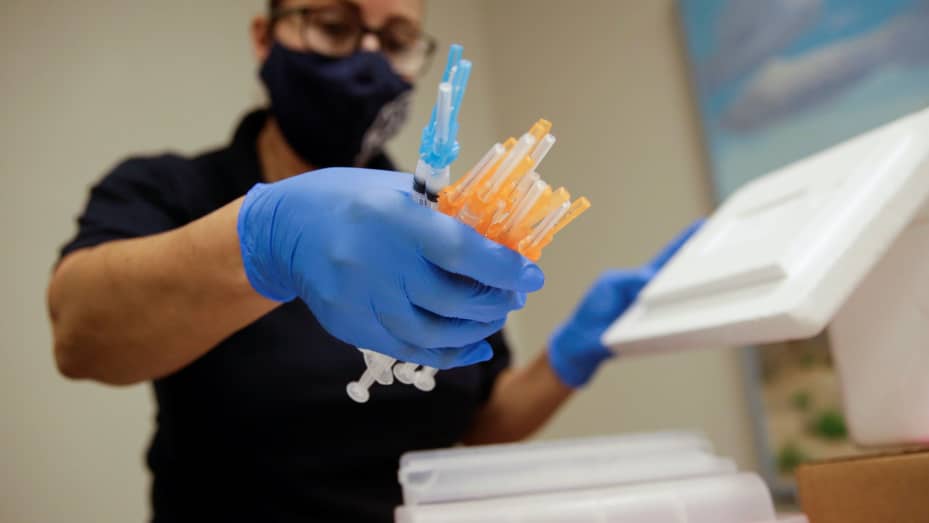 A healthcare worker holds syringes with the Moderna and Pfizer vaccines against the coronavirus disease (COVID-19) at a vaccination centre, in El Paso, Texas, May 6, 2021.