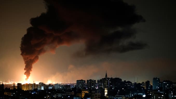 A huge column of smoke seen from Gaza city billows from an oil facility in the southern Israeli city of Ashkelon, on May 11, 2021, after rockets were fired by the Palestinian Hamas movement from the Gaza Strip towards Israel.