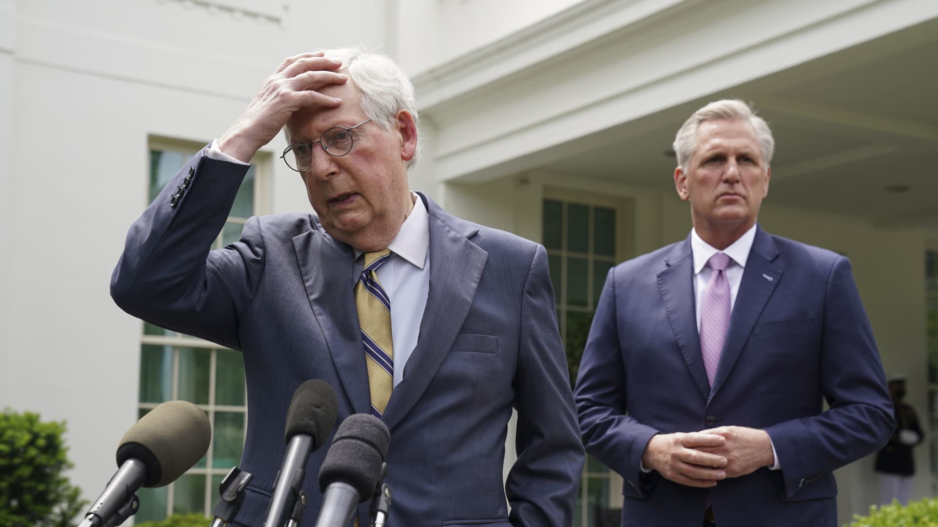 Senate Minority Leader Mitch McConnell puts his hand to his head as he and House Minority Leader Kevin McCarthy speak to reporters following an infrastructure meeting with U.S. President Joe Biden at the White House in Washington, U.S., May 12, 2021.