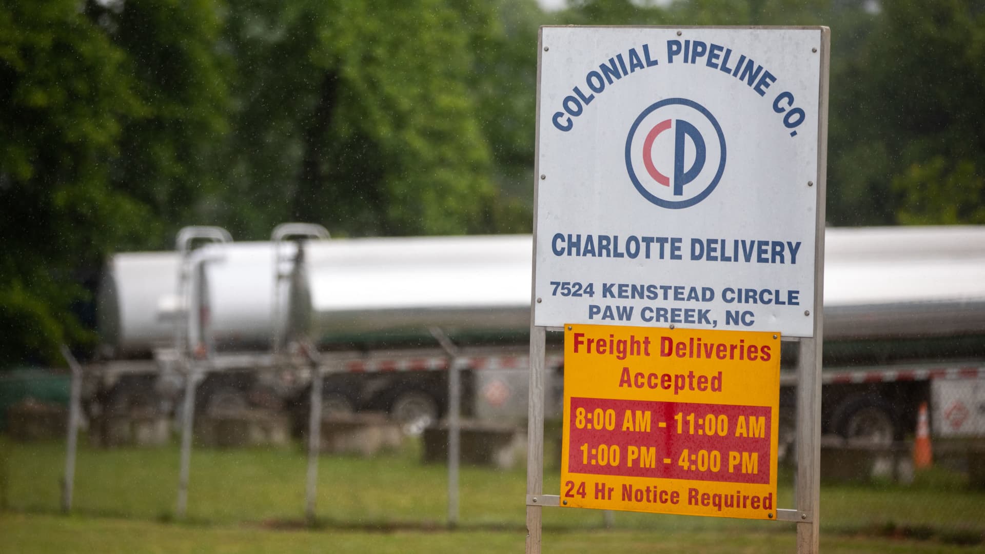 Tanker trucks can be seen in an adjacent lot next to the entrance of the Colonial Pipeline tank farm in Charlotte, North Carolina on May 12, 2021.