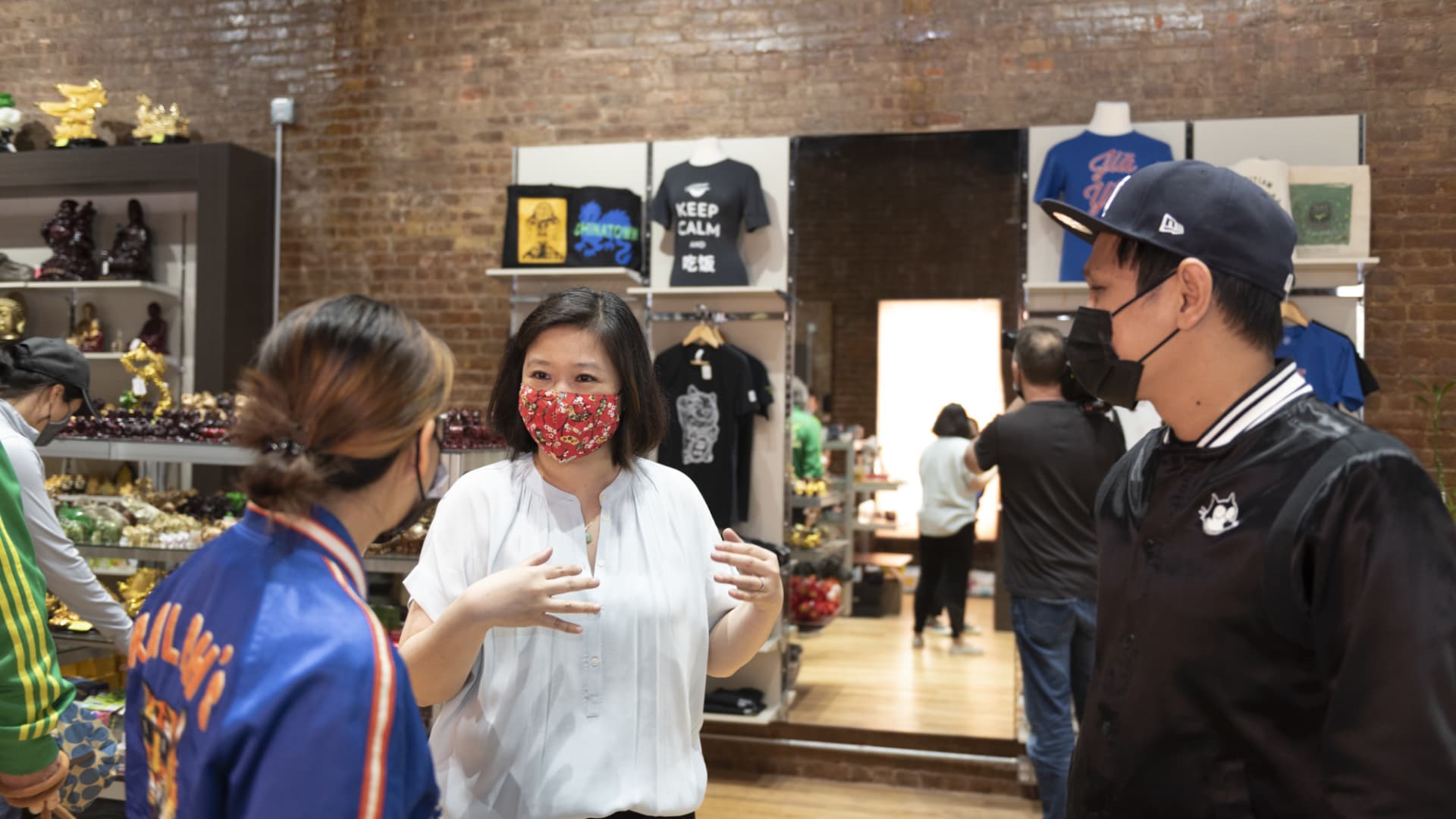 Joanne Kwong, president of Pearl River Mart, talks with customers at the business' newest location in Soho, New York City.