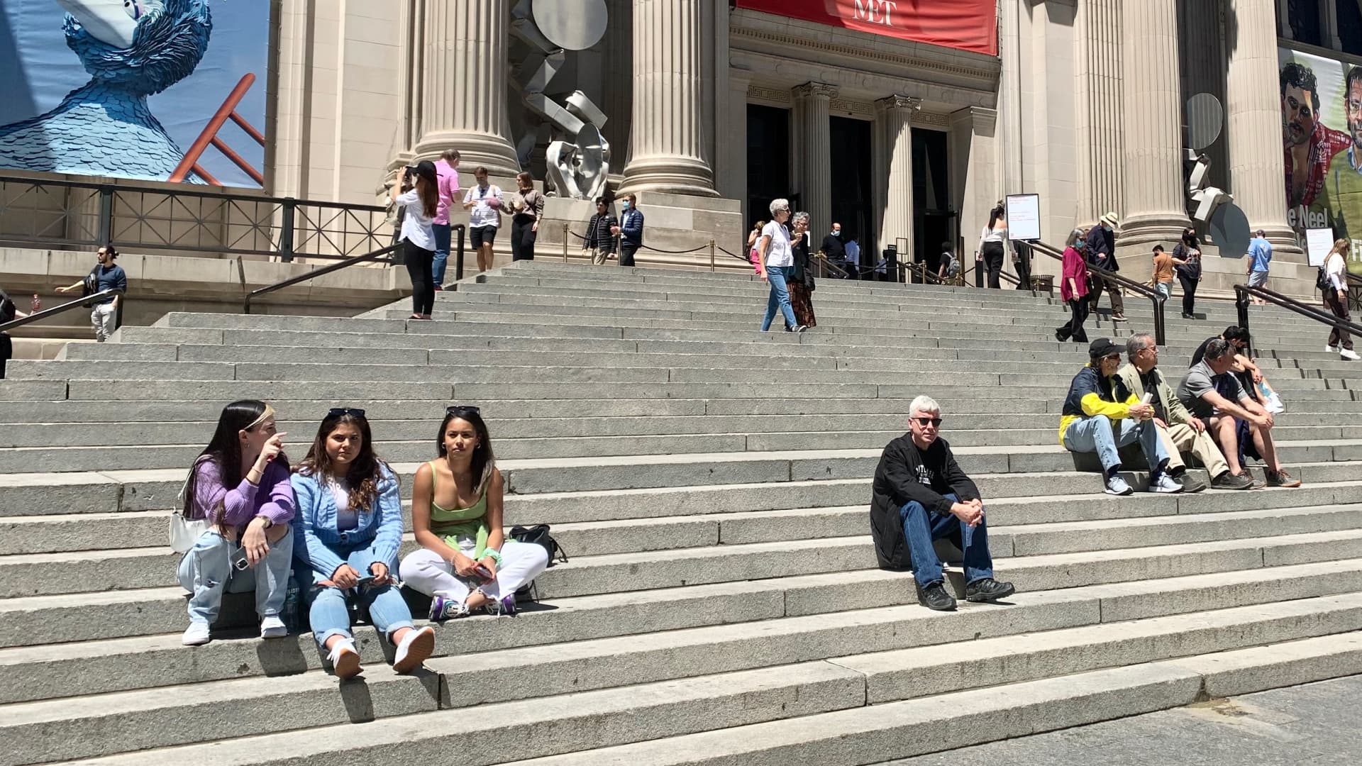 People enjoying the sunshine on the steps of The MET in New York City as the CDC lifts restrictions on mask wearing for those who are fully vaccinated.