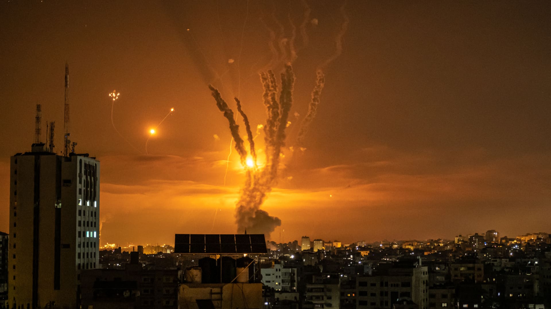 Rockets launched towards Israel from the northern Gaza Strip and response from the Israeli missile defense system known as the Iron Dome leave streaks through the sky on May 14, 2021 in Gaza City, Gaza.