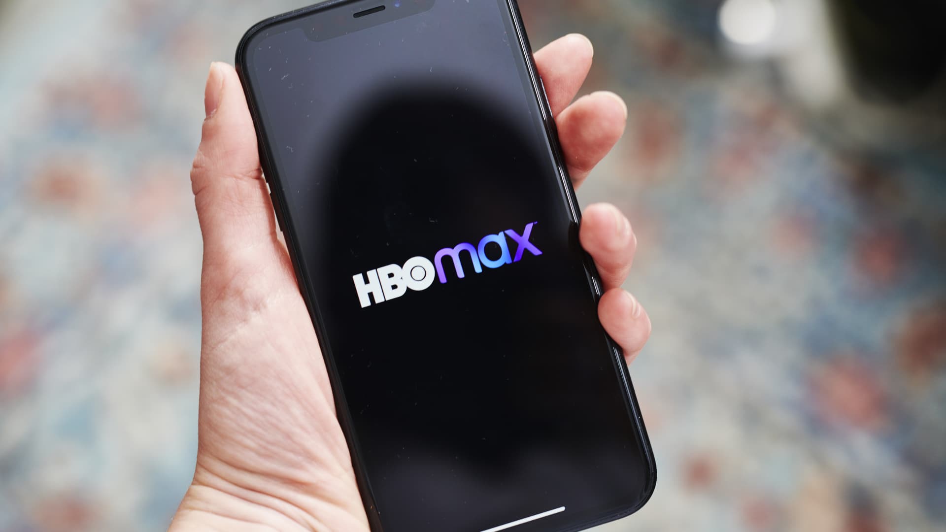 Signage for the AT&T Inc. WarnerMedia HBO Max streaming service is displayed on a smartphone in an arranged photograph taken in the Brooklyn Borough of New York, U.S., on Thursday, May 28, 2020.