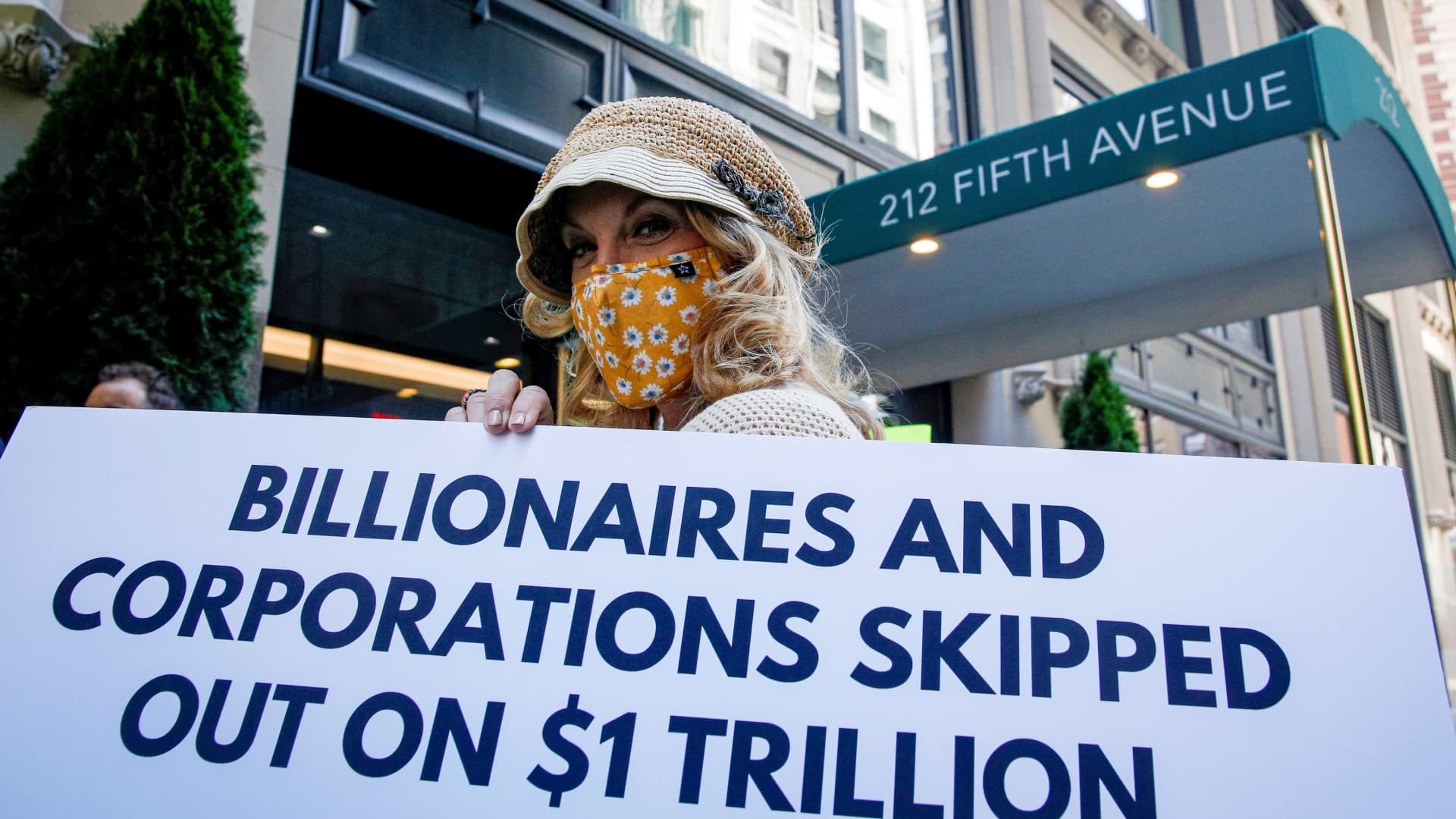 Members of the Patriotic Millionaires hold a federal tax filing day protest outside the apartment of Amazon founder Jeff Bezos, to demand he pay his fair share of taxes, in New York City, May 17, 2021.