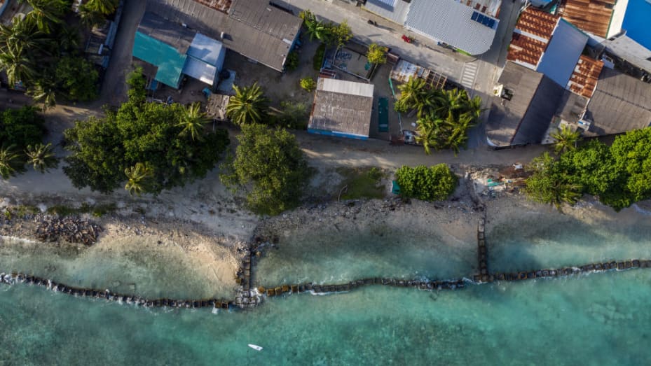 Concrete blocks are placed along the shoreline to try and prevent further coastal erosion in Mahibadhoo, Maldives.