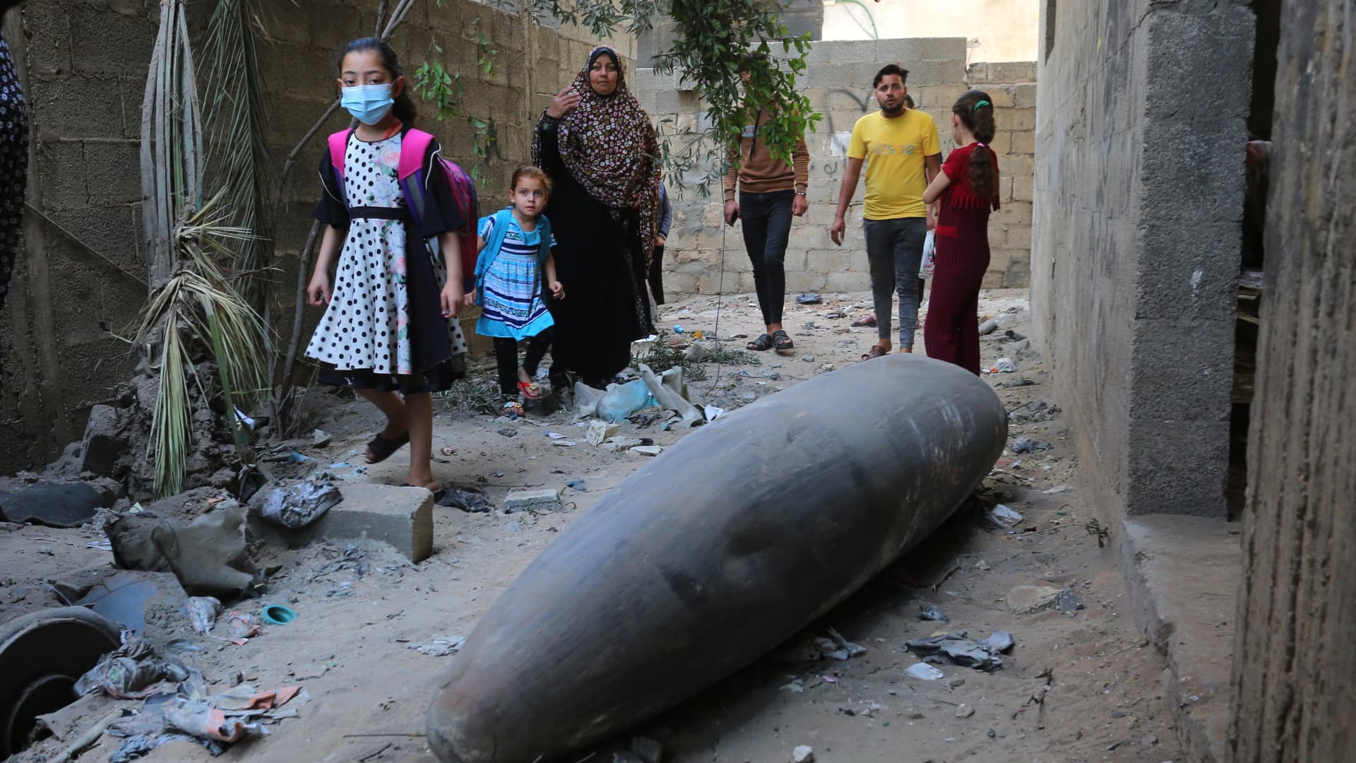 People look at an unexploded missile thrown by Israel in al-Rimal neighborhood as Israeli warplanes continue to carry out airstrikes in Gaza City, Gaza on May 18, 2021.