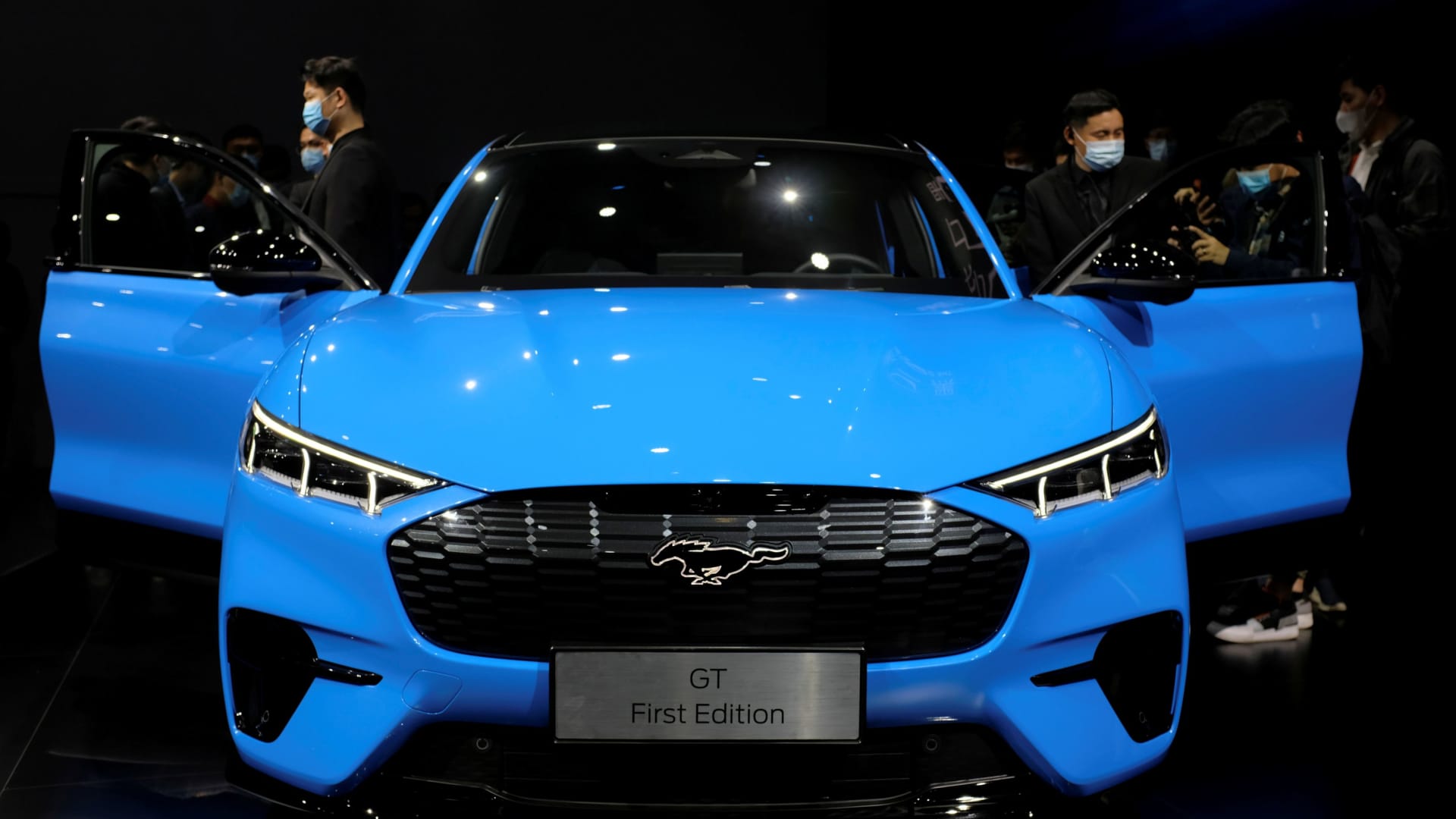 Visitors check on a Ford Mustang Mach-E electric vehicle displayed at a launch event in Shanghai, China April 13, 2021.
