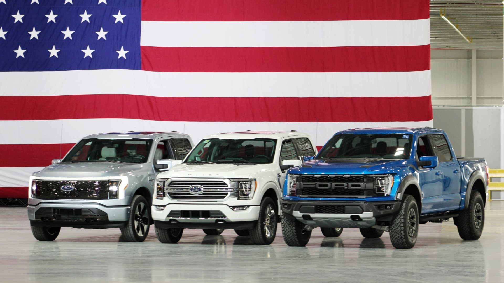 Ford revealed its highly anticipated all-electric F-150 Lightning pickup truck (left) at Ford's Rouge Electric Vehicle Center in Dearborn, Mich. during a tour by President Joe Biden on May 18, 2021.