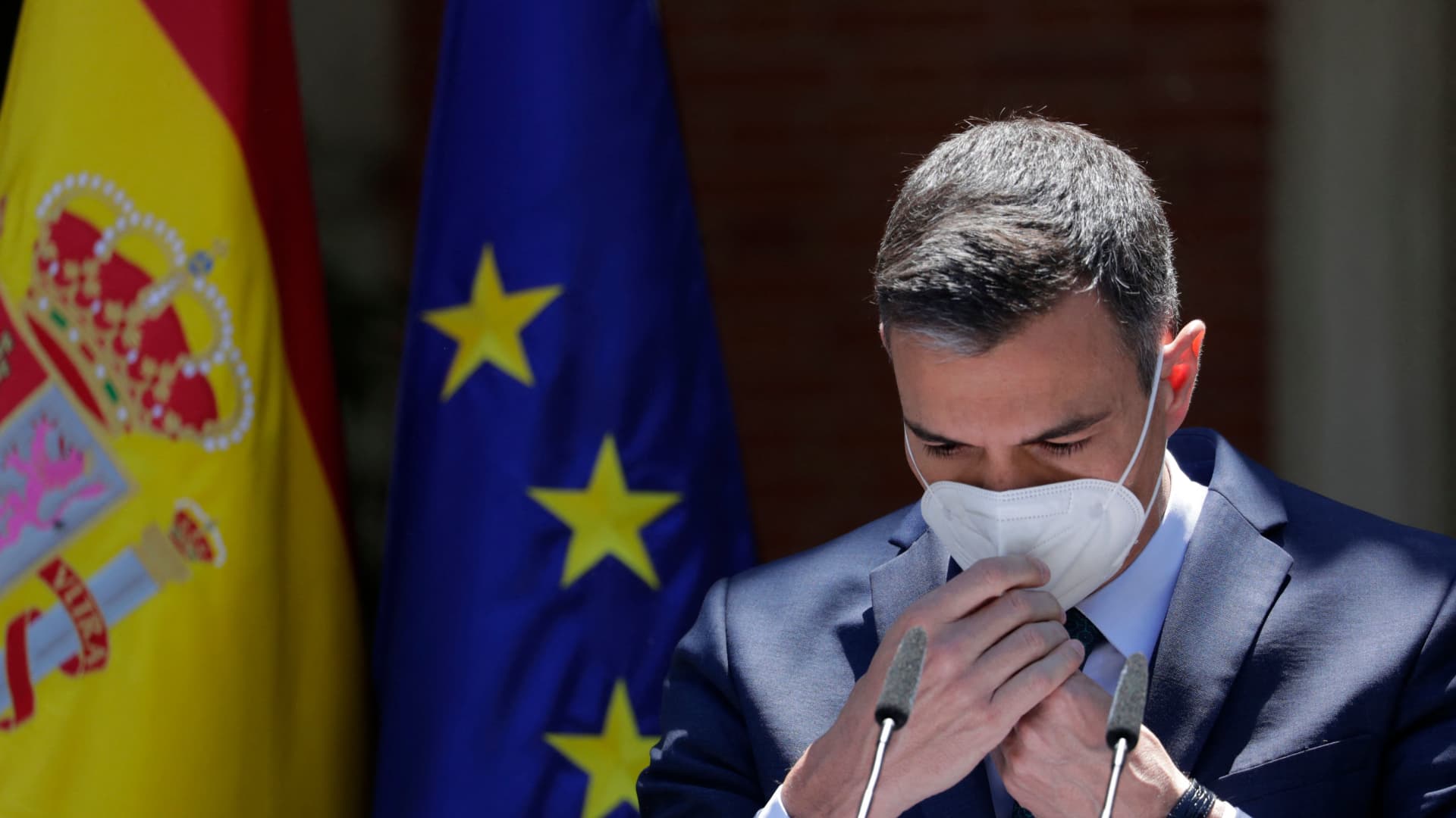 Spain's Prime Minister Pedro Sanchez puts on his mask after making a statement at the Moncloa Palace in Madrid, on May 18, 2021.