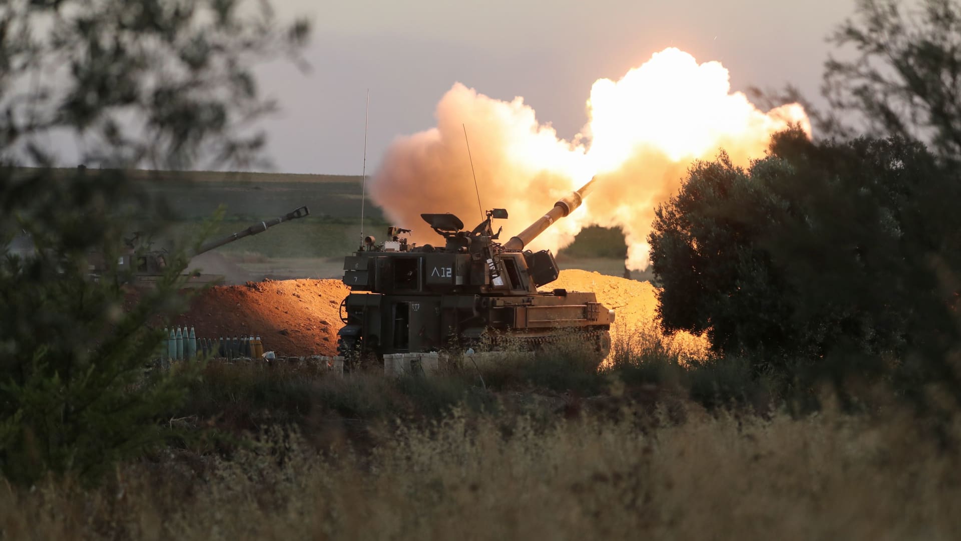 Israeli soldiers work in an artillery unit as it fires near the border between Israel and the Gaza strip, on the Israeli side May 19, 2021.