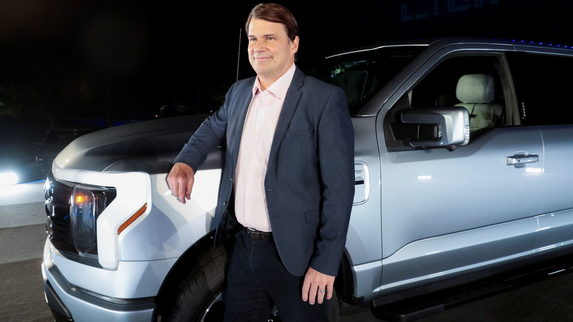 Ford CEO Jim Farley poses with the Ford F-150 Lightning pickup truck in Dearborn, Michigan, May 19, 2021.
