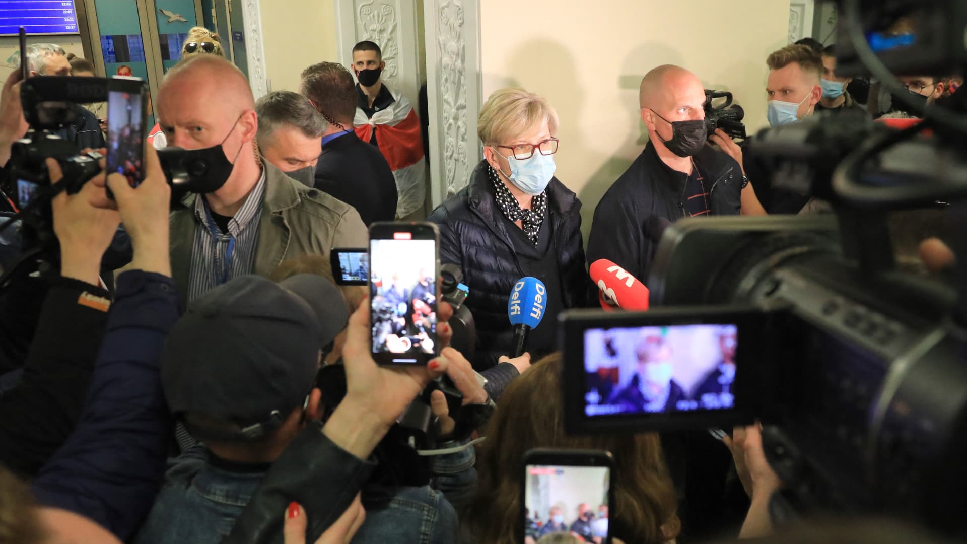 Lithuanian Prime Minister Ingrida Simonyte (C) speaks to journalists at Vilnius International Airport on May 23, 2021, following the landing of the Ryanair passenger plane.