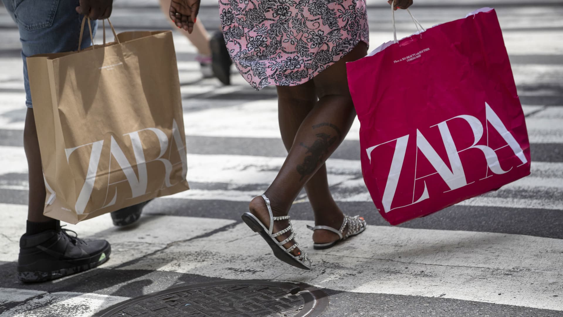 Shoppers carry Zara bags on Fifth Avenue in New York, on Saturday, May 22, 2021.