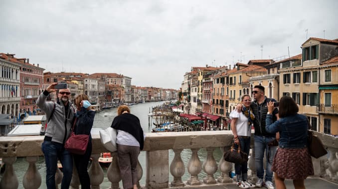 Tourists take pictures on the Rialto Bridge in Venice, Italy on May 21, 2021.