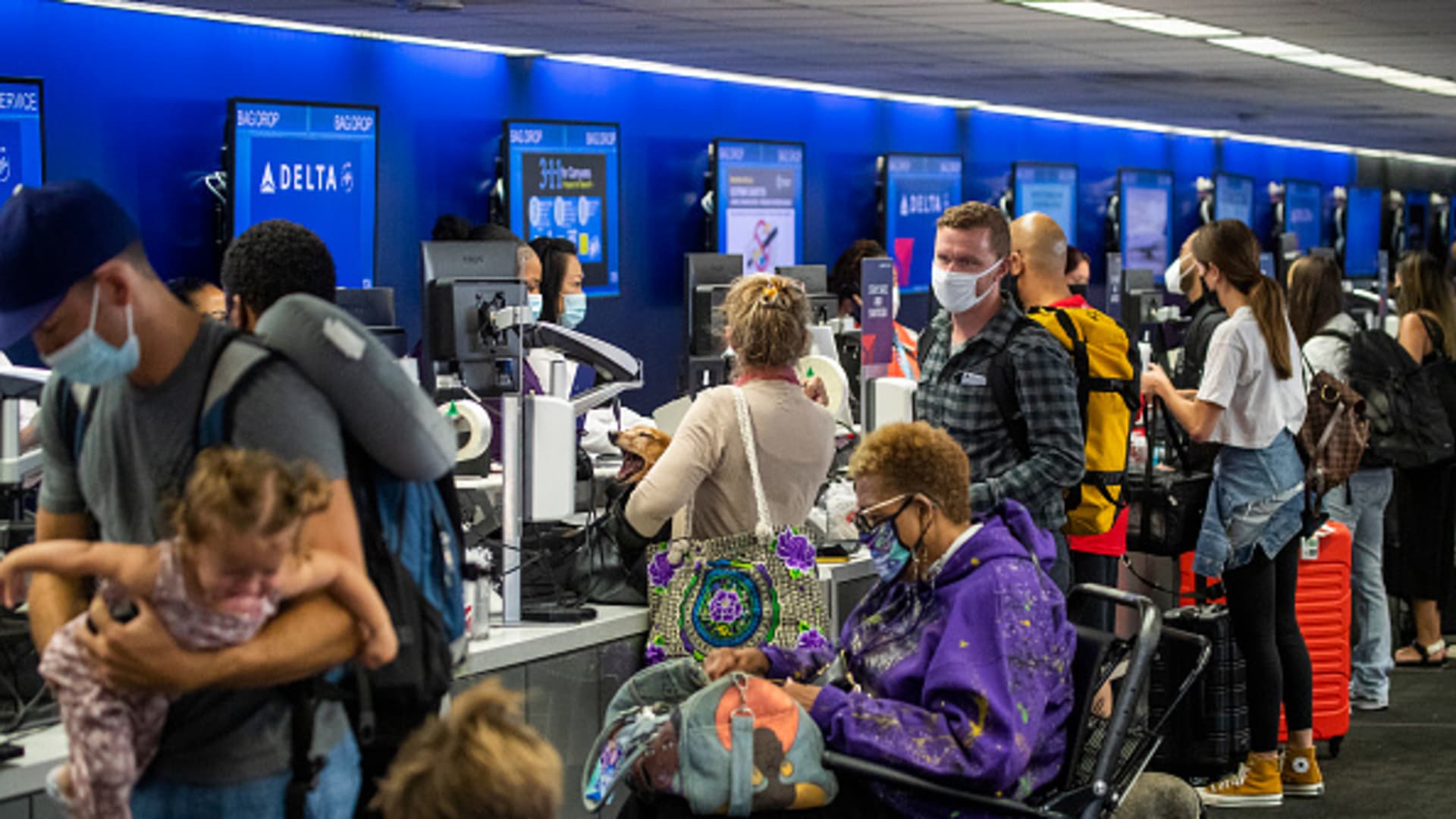 A crowd of travelers check in for their flights at LAX on Friday, May 28, 2021.