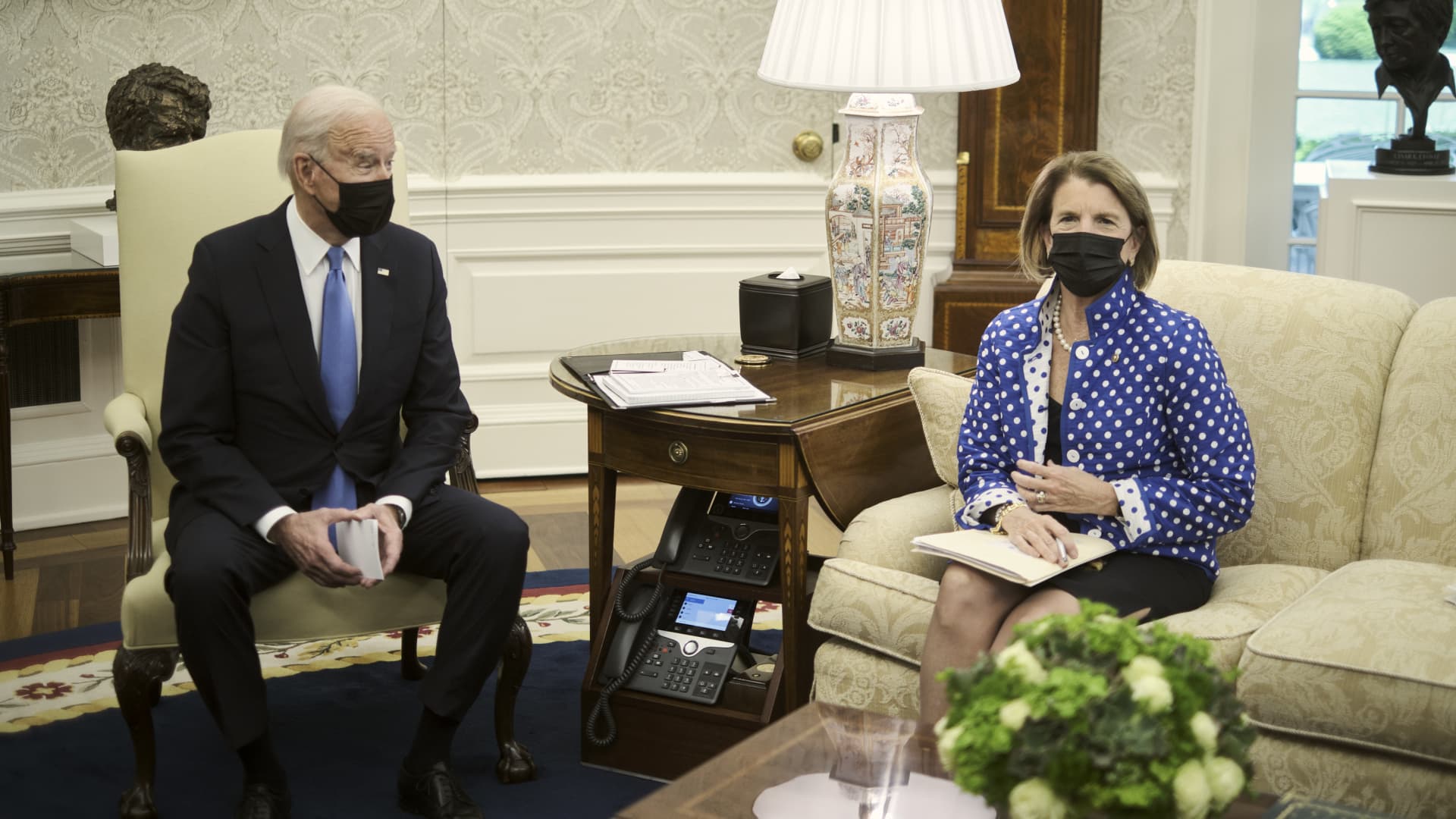 U.S. President Joe Biden, left, wears a protective mask while speaking during a meeting with Senator Shelley Moore Capito, a Republican from West Virginia, in the Oval Office of the White House in Washington, D.C., U.S., on Thursday, May 13, 2021.
