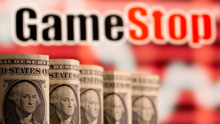 U.S. one dollar banknotes are seen in front of displayed GameStop logo in this illustration taken February 8, 2021.