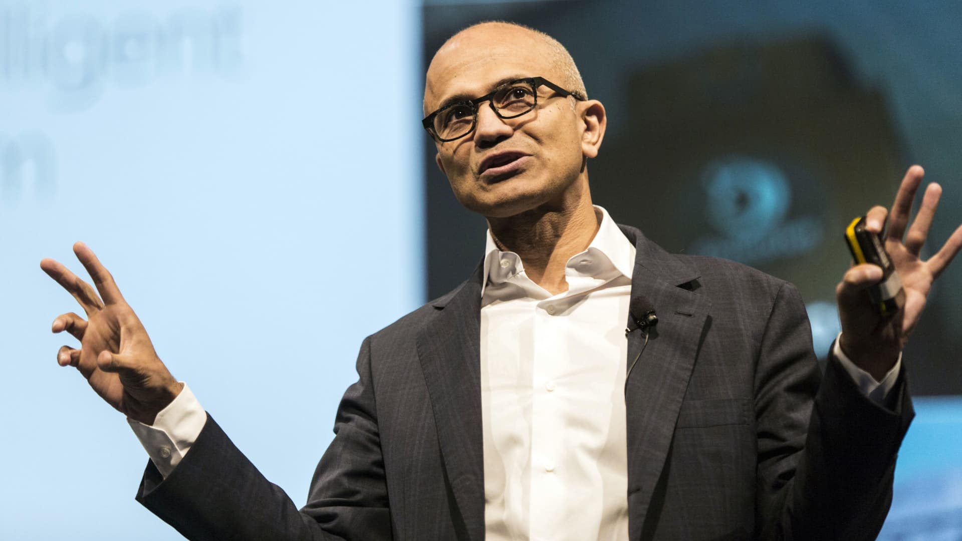 Satya Nadella, chief executive officer of Microsoft Corp., speaks during the opening keynote session at the Microsoft Developer Day in Singapore, on Friday, May 27, 2016. Microsoft has all but abandoned the smartphone game. The company said Wednesday that it will axe as many as 1,850 jobs, many of them in Finland -- home base of the handset business Microsoft acquired two years ago from Nokia Oyj.