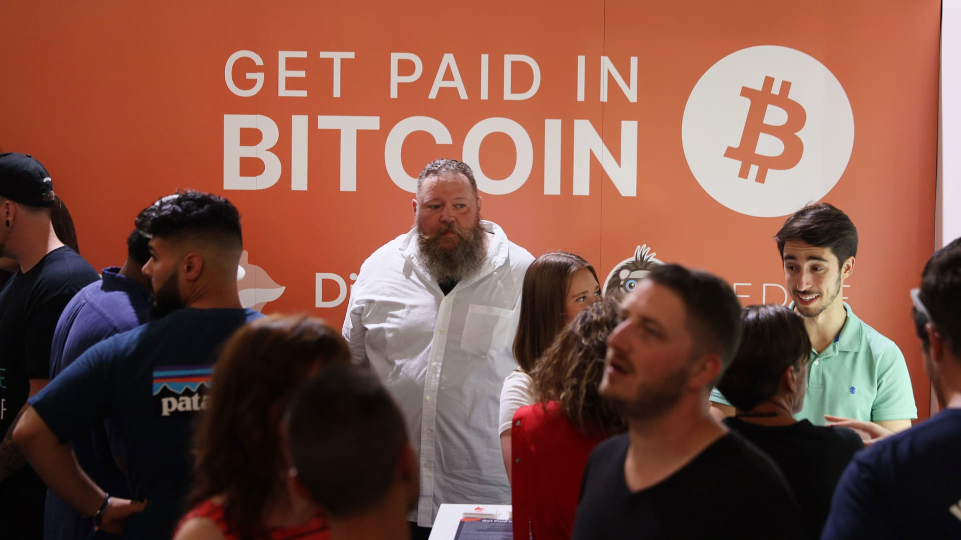 Dave Pope (center) works in the Digifox booth setup at the Bitcoin 2021 Convention, a cryptocurrency conference held in Miami on June 4, 2021.