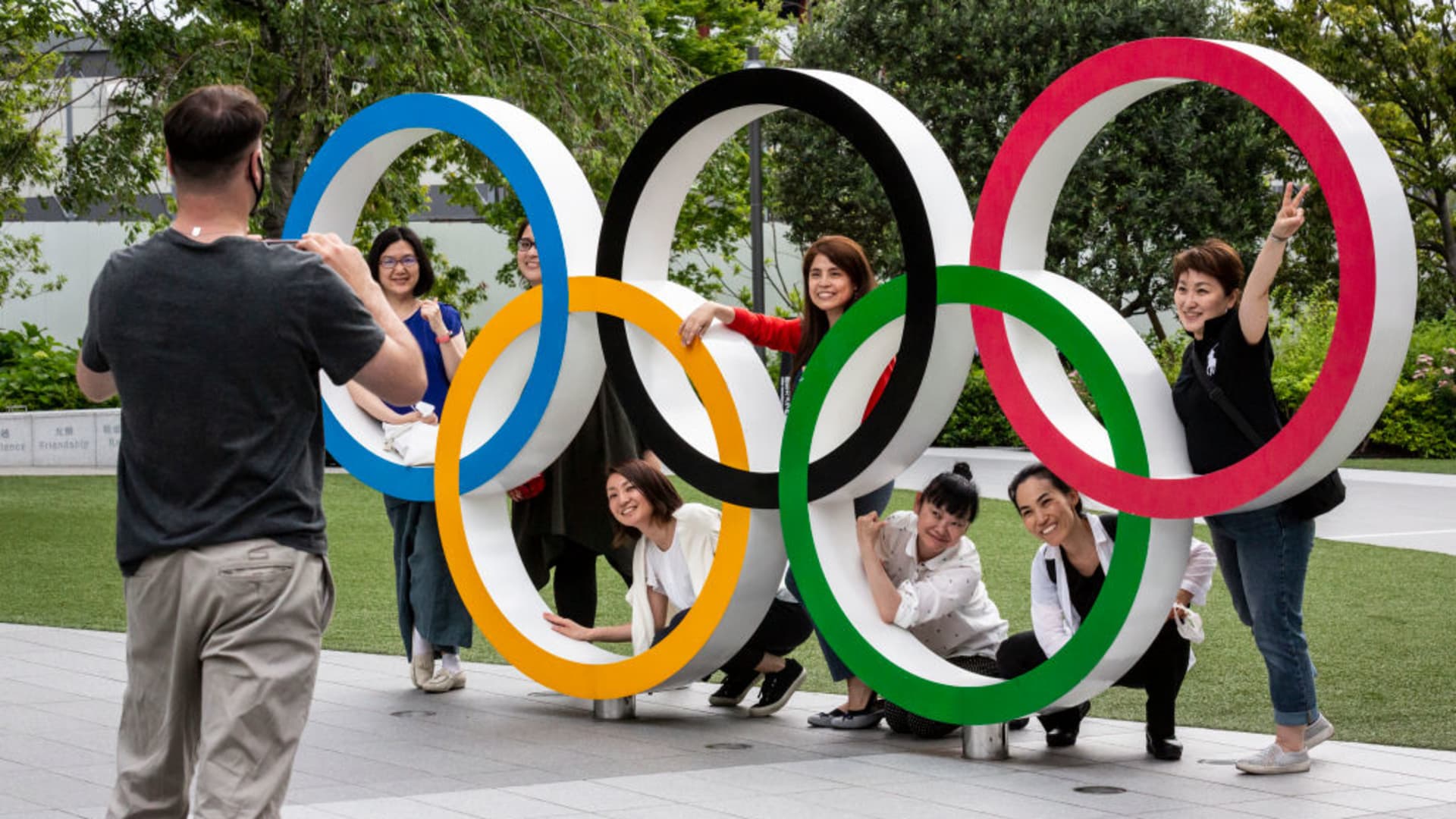 People have their photographs taken next to the Olympic Rings on June 03, 2021 in Tokyo, Japan. Tokyo 2020 president Seiko Hashimoto has stated that she is 100 percent certain that the Olympics will go ahead despite widespread public opposition as Japan grapples with a fourth wave of coronavirus.