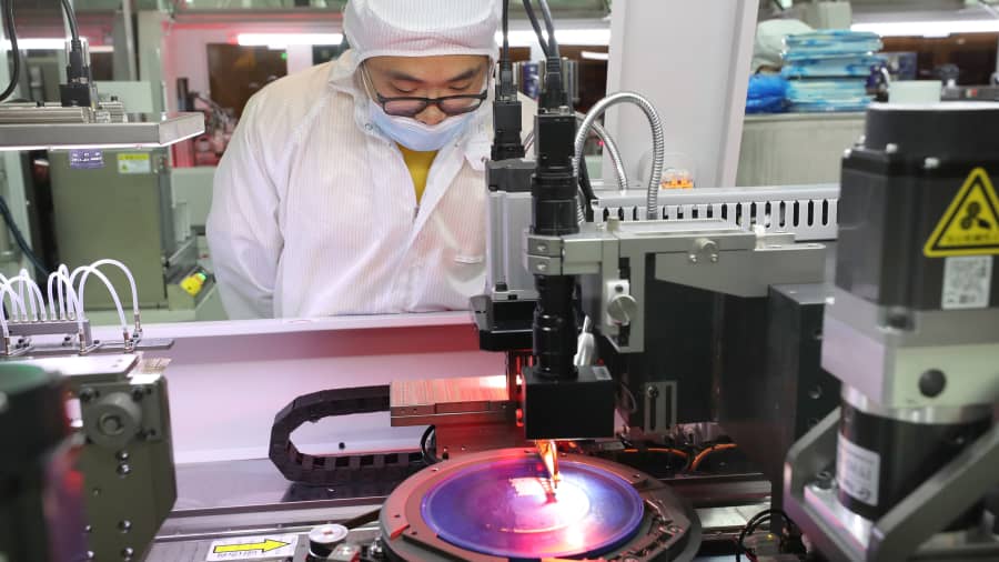 Employees work on the production line of silicon wafer at a workshop of Jiejie Semiconductor Co., Ltd on March 17, 2021 in Nantong, Jiangsu Province of China.