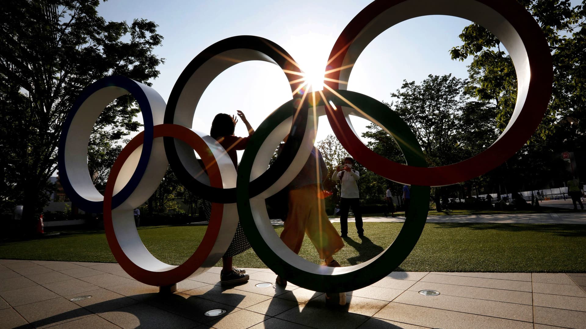 Visitors try to take photos in front of the Olympic Rings monument outside the Japan Olympic Committee (JOC) headquarters near the National Stadium, the main stadium for the 2020 Tokyo Olympic Games that have been postponed to 2021 due to the coronavirus disease (COVID-19) outbreak, in Tokyo, Japan May 30, 2021.