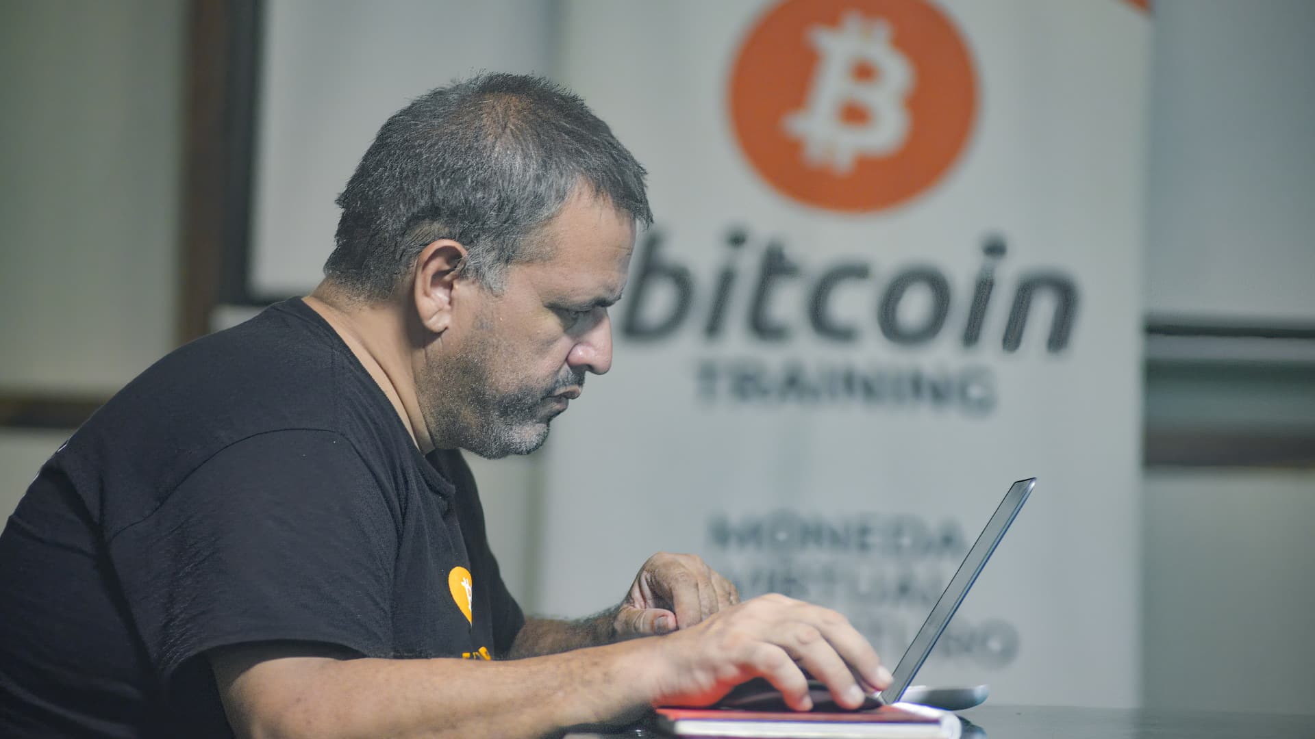 A man works on a laptop at a Bitcoin training facility. Salvadoran President Nayib Bukele has announced that he will propose a law to the Congress, where his party controls a majority, for Bitcoin to become legal tender.