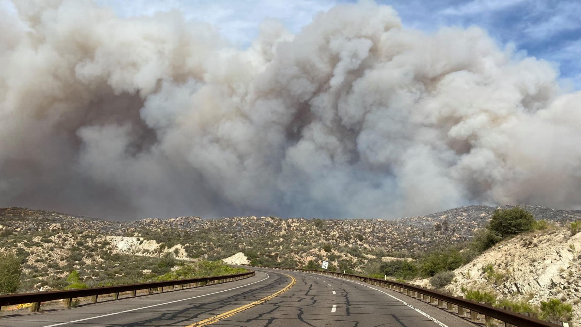 Smoke plumes rise from a blaze as a wildfire rages on in Arizona, U.S., June 7, 2021, in this image obtained from social media.