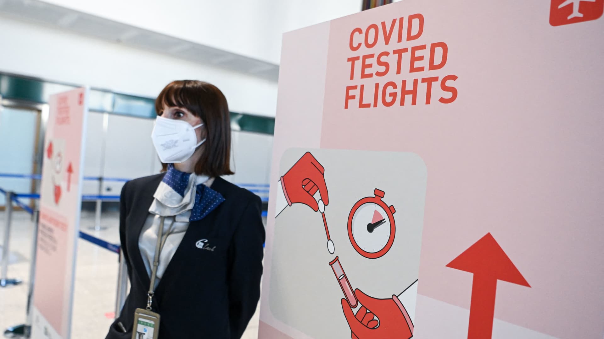 An airport hostess waits to assist passengers going through a rapid Covid-19 testing area at Malpensa Airport in Milan, Italy, on April 2, 2021.