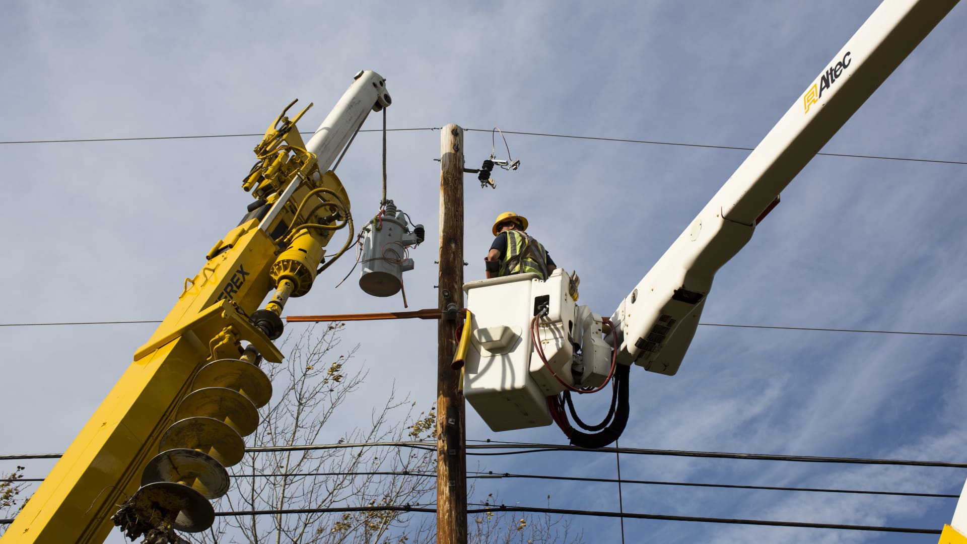 Green Mountain Power workmen add a transformer to residential power lines in Charlotte, Vermont.